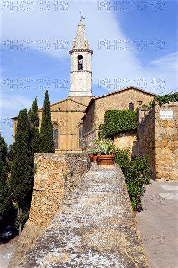 ITALY, Tuscany, Pienza, Val D'Orcia The belltower of the Duomo built in 1459 by the architect Rossellino for Pope Pius II seen from the Via Dell' Amore with cypress trees.