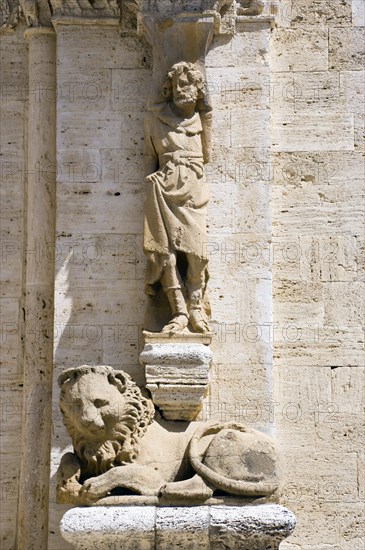 ITALY, Tuscany, San Quirico D'Orcia, One of the caryatid or zoomorphic columns of the portale di mezzogiorno or southern door of the Collegiata the Church of the saints Quirico and Giulitta attributed to the school of Giovanni Pisano showing a man and a lion