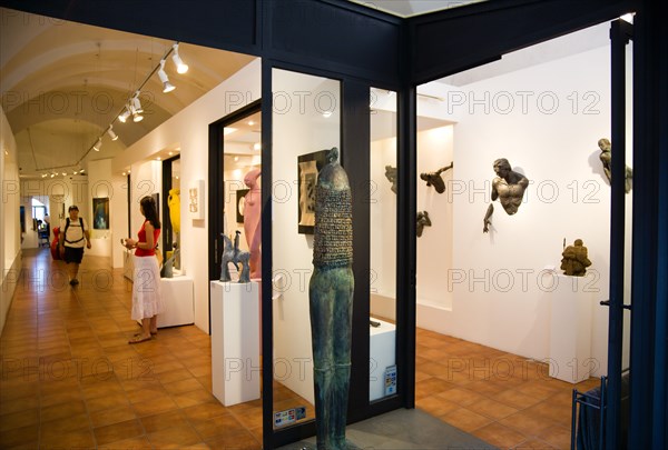 ITALY, Tuscany, San Gimignano, Modern Art gallery with visitors.