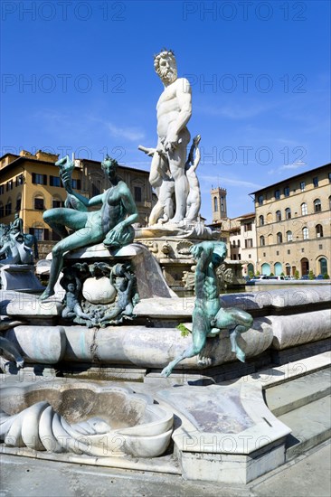 ITALY, Tuscany, Florence, The 1575 Mannerist Neptune fountain with the Roman sea God surrounded by water nymphs commemorating Tuscan naval victories by Ammannatti in the Piazza della Signoria beside the Palazzo Vecchio.