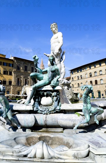 ITALY, Tuscany, Florence, The 1575 Mannerist Neptune fountain with the Roman sea God surrounded by water nymphs commemorating Tuscan naval victories by Ammannatti in the Piazza della Signoria beside the Palazzo Vecchio.