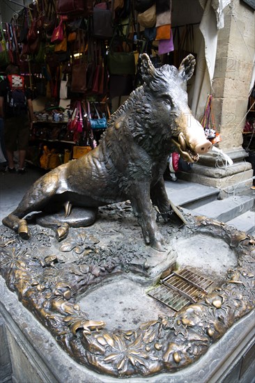 ITALY, Tuscany, Florence, The 17th century bronze fountain called Il Porcellino in the Mercato Nuovo also known as the Straw Market where the snout of the wild boar shines where people rub it under the superstition that if you do you will return to the city.