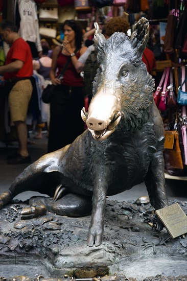 ITALY, Tuscany, Florence, The 17th century bronze fountain called Il Porcellino in the Mercato Nuovo also known as the Straw Market where the snout of the wild boar shines where people rub it under the superstition that if you do you will return to the city.