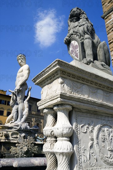 ITALY, Tuscany, Florence, The 1575 Mannerist Neptune fountain with the Roman sea God surrounded by water nymphs commemorating Tuscan naval victories by Ammannatti in the Piazza della Signoria beside the Palazzo Vecchio.