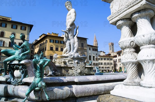 ITALY, Tuscany, Florence, The 1575 Mannerist Neptune fountain with the Roman sea God surrounded by water nymphs commemorating Tuscan naval victories by Ammannatti in the Piazza della Signoria beside the Palazzo Vecchio.