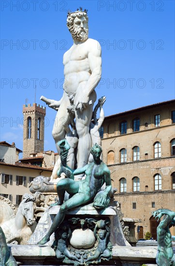 ITALY, Tuscany, Florence, The 1575 Mannerist Neptune fountain with the Roman sea God surrounded by water nymphs commemorating Tuscan naval victories by Ammannatti in the Piazza della Signoria beside the Palazzo Vecchio.