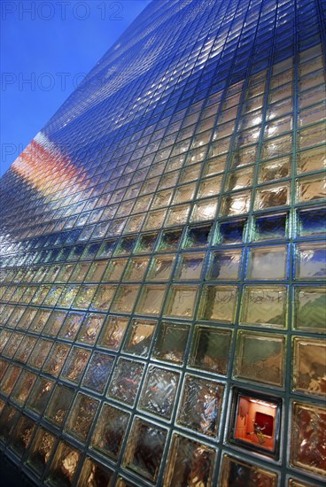 Japan, Honshu, Tokyo, Ginza, nightime view of the glass block facade of the Hermes Building.