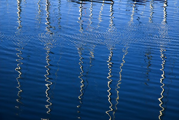 IRELAND, County Dublin, Howth Harbour, Reflection of yachts in the water.