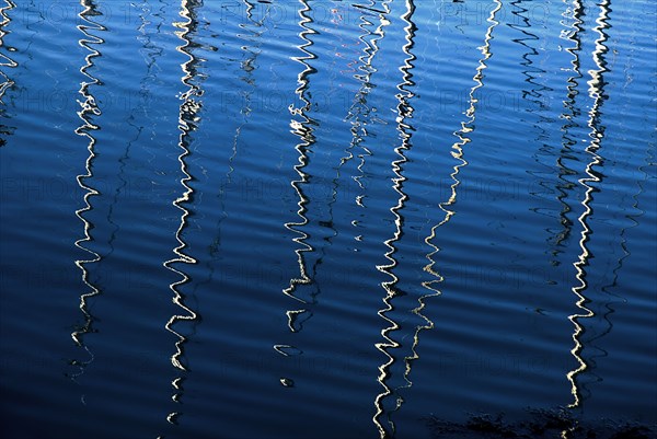 IRELAND, County Dublin, Howth Harbour, Reflection of yachts in the water.