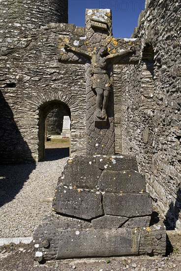 IRELAND, County Louth, Monasterboice Monastic Site, Crucifixion scene in stone situated in church ruin.