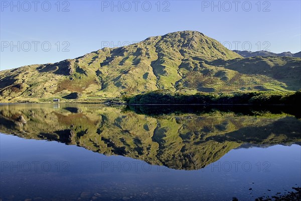 IRELAND, County Galway, Connemara, Kylemore Lough with Benbaun Mountain behind.