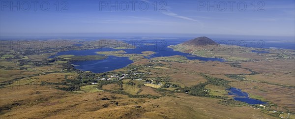 IRELAND, County Galway, Connemara, Diamond Hill,  Ballynakill Harbour as seen from the slopes of the hill  Hikers at viewpoint.