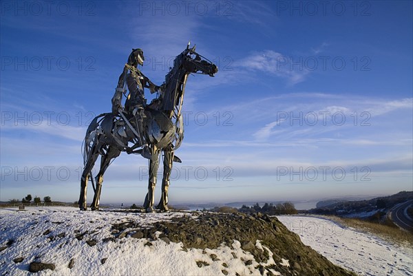 IRELAND, County Roscommon, Boyle, the Chieftain sculpture near Boyle with Lough Key in the background.