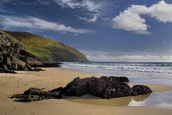 IRELAND, County Kerry, Dingle Peninsula, Coumeenole Beach at Slea Head  Incoming waves with rocks on shoreline.
