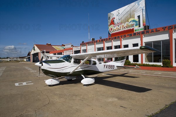 VENEZUELA, Bolivar State, Ciudad Bolivar, Airport with Cessna airplane parked outside the main terminal at ciudad Bolivar city airport