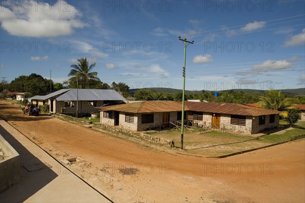 VENEZUELA, Bolivar State, Canaima National Park, Canaima Village, View of the main street junction of Canaima village known as the gateway to Angel Falls , shoot from a height level on a bright day with blue sky and white clouds.