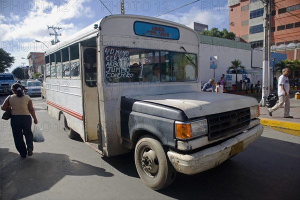 VENEZUELA, Margarita Island, Porlamar, Local route bus, old and in bad state, shoot at the streets of Porlamar on a bright sunny day with blue sky and white clouds.