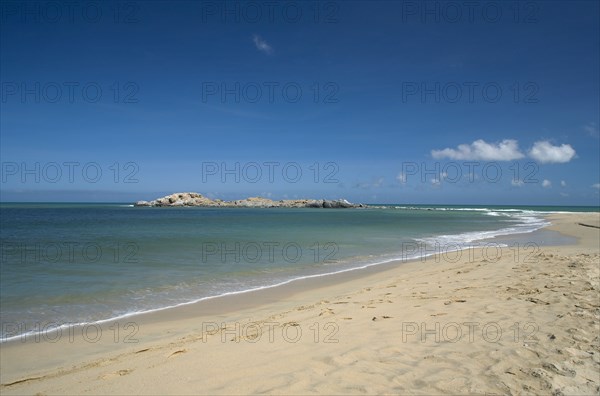 VENEZUELA, Margarita Island, Playa Caribe, View of exotic beach with its tropical crystal clear seawaters shoot on a bright day with blue sky and white clouds.