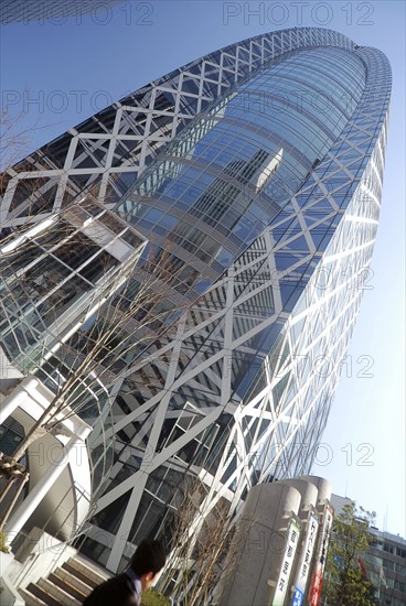 Japan, Tokyo, Shinjuku, Cocoon Building, unusual design, man walking by in front.