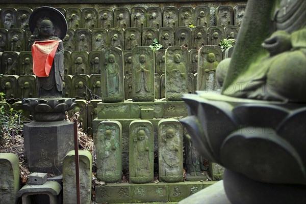 Japan, Tokyo, Nippori, Jyomo-in shrine, dozens of stone Jizo statues of Buddha.