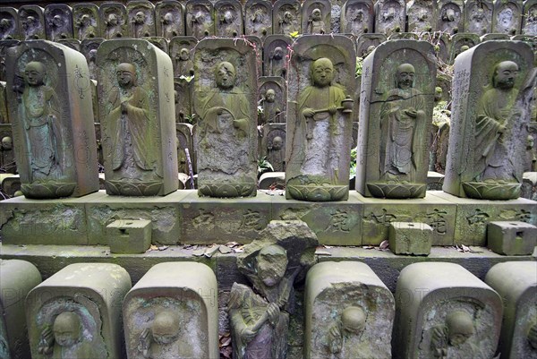 Japan, Tokyo, Nippori, Jyomo-in shrine, dozens of stone Jizo statues of the Buddha.