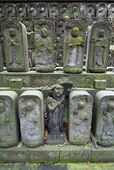 Japan, Tokyo, Nippori, Jyomo-in shrine, dozens of stone Jizo statues of the Buddha.