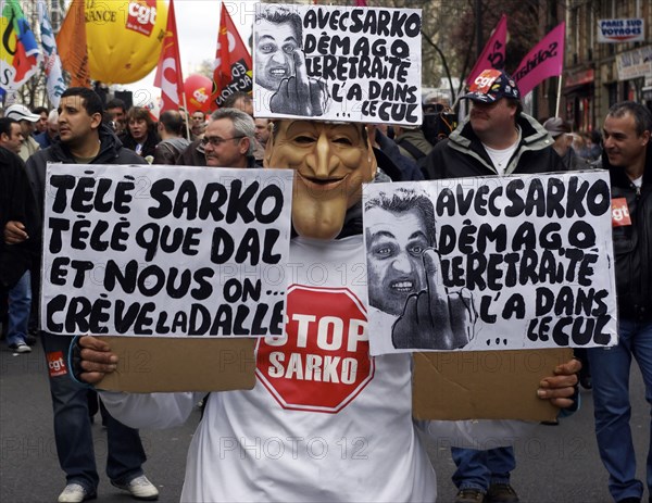 France, Paris, Rue de Faubourg Saint Antoine, A Nicolas-Sarkozy masked protestor marches down the street during a manifestion against French governments moves against the country's retirement laws.