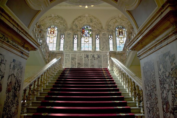 Ireland, North, Belfast, City Hall, Interior with stairs leading up past stained glass windows.