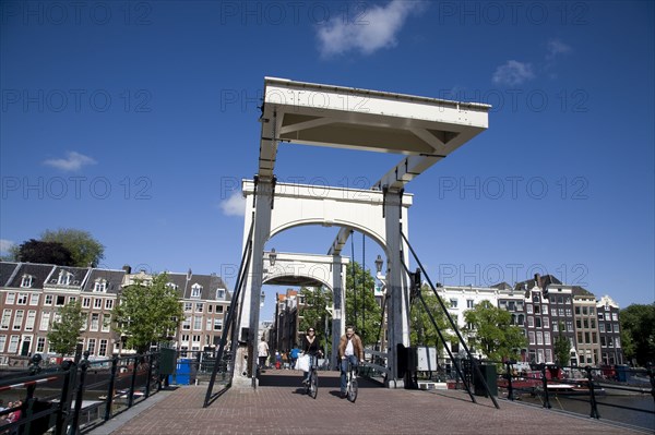 Netherlands, Amsterdam, Magere Brug or Skinny Bridge with cyclists.