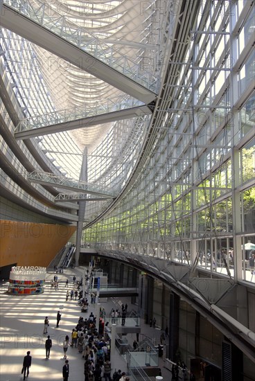 Japan, Tokyo, Yurakucho, the International Forum Building, the atrium lobby, all glass, outside courtyard and trees visible off upper level.