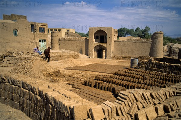 Iran, Yazd Province, Meybod, Mud brick making in ancient mud city.