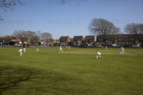 England, West Sussex, Southwick, Local Cricket team playing on village green.