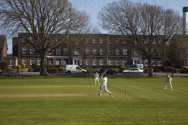 England, West Sussex, Southwick, Local Cricket team playing on village green.