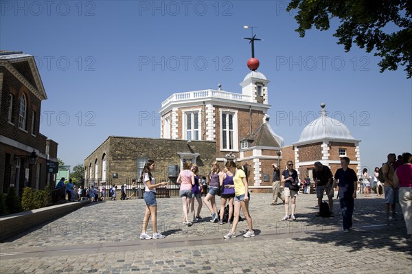 England, London, Greenwich Royal Observatory, shchool girls walking on the Meridian line in the ground.