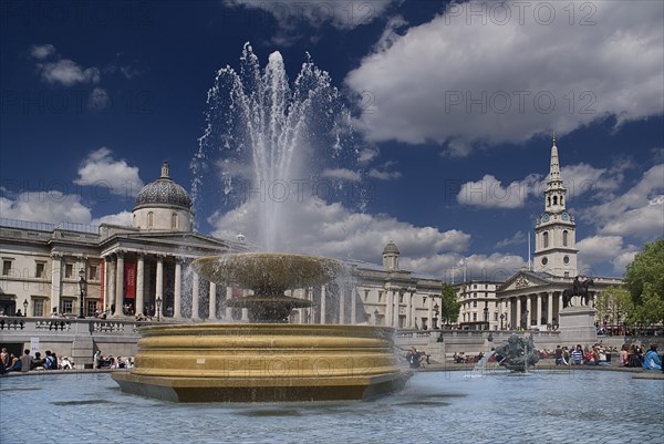 England, London, Trafalgar Square, Fountan with the National Gallery behind.