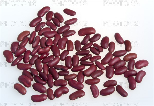 Food, Uncooked, Beans, Red kidney beans scattered on a white surface.