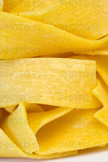 Food, Uncooked, Pasta, Ribbons of durum wheat Pappardelle against a white background.