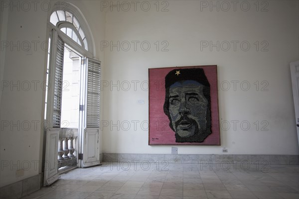 Cuba, Havana, Centro Habana, Refugio 1, exhibition room at the museum of the revolution with a colored painting on the wall inspired by Fidel Castro.