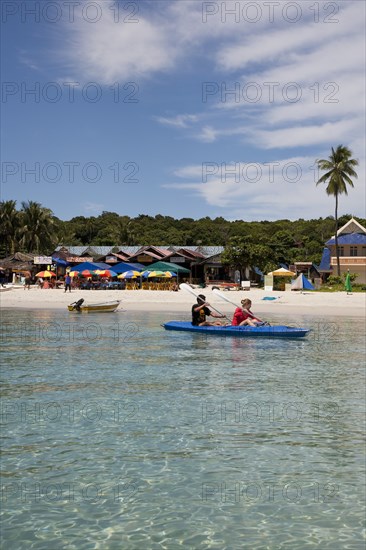 Malaysia, Pulau Perhentian Kecil, Terrengganu coast with two people canoeing close to beach.