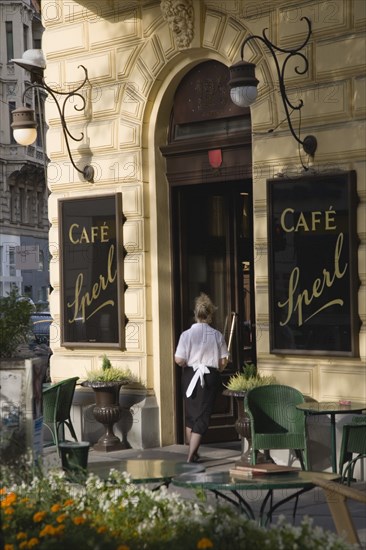 Republic of Austria, Vienna, Mariahilf, the 6th District, Café Sperl, Adolf Hitler's preferred café, Waitress carrying coffee order, customers sat outside in a Schanigarten.
The Café Sperl, now over 120 years established, offers billiards and forbids mobile phones