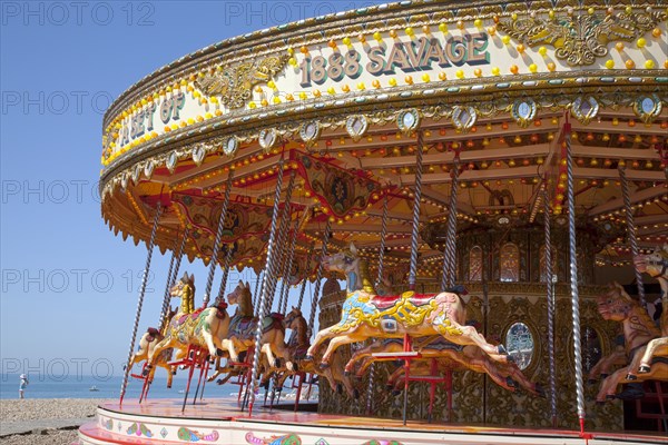 England, East Sussex, Brighton, Carousel on the pebble beach promenade.