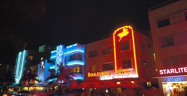 Miami, Florida, USA. South Beach Ocean Drive Art Deco Buildings at night Colony & Boulevard Hotels with neon signs. Nite North America Sand Sandy Beaches Tourism Seaside Shore Tourist Tourists Vacation Southern Sunshine State United States of America