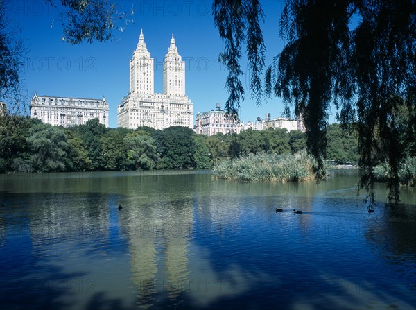 New York City, New York, USA. Central Park. View over The Lake toward city architecture on the western edge American Blue Destination Destinations North America Northern United States of America
