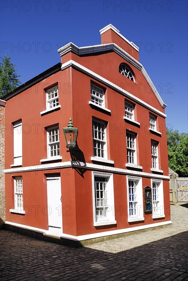 Omagh, County Tyrone, Ireland. Ulster American Folk Park red coloured house in the reconstructed 19th century American streetscape. Ireland Irish Eire Erin Europe European North Northern County Tyrone Omagh Ulster American US Folk Park Museum Living Tour Tourism Tourist Attraction Travel Architecture Red Color Colored Colour Coloured House Home Exterior American Blue Sky Destination Destinations History Historic Northern Europe Poblacht na hEireann Republic Sightseeing Tourists Holidaymakers