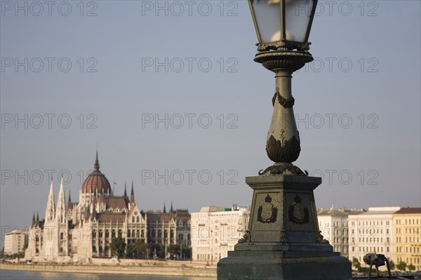 Budapest, Pest County, Hungary. Detail of Szechenyi Chain Bridge or Memory Bridge with Hungarian Parliament Building seen behind on Pest bank of the River Danube. Hungary Hungarian Europe European East Eastern Buda Pest Budapest City Cityscape River Danube Parliament Bridge Szechenyi Chain Memory Destination Destinations Eastern Europe Parliment