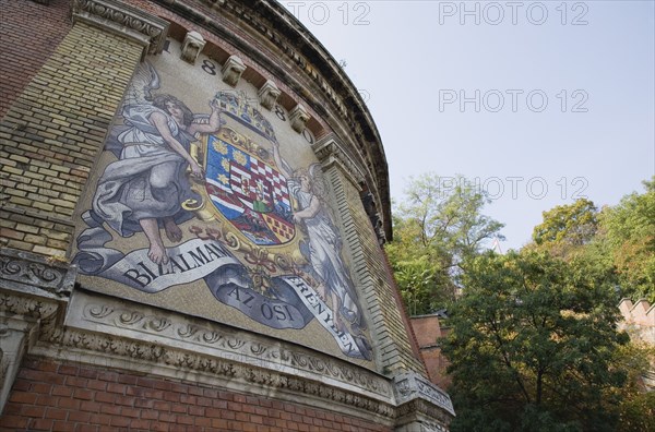 Budapest, Pest County, Hungary. Mural depicting coat of arms at entrance to Siklo Funicular. Hungary Hungarian Europe European East Eastern Buda Pest Budapest City Architecture Art Exterior Facade Painted Mural Destination Destinations Eastern Europe