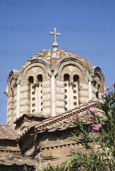 Athens, Attica, Greece. The Church of the Holy Apostles also known as Holy Apostles of Solaki located in the Ancient Agora of Athens and can be dated to around the late tenth century. Part view of extrior and domed tiled roof with cross at centre. Greece Greek Attica Athens Europe European Vacation Holiday Holidays Travel Destination Tourism Ellas Hellenic Church Holy Apostles Solaki Agora Ancient Religion Religious Christian Christianity Exterior Atenas Athenes Blue Center Destination Destinations Ellada History Historic Religion Religious Christianity Christians Southern Europe