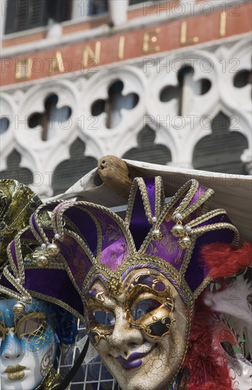 Venice, Veneto, Italy. Carnival masks in front of partly seen facade of Hotel Danieli. Italy Italia Italian Venice Veneto Venezia Europe European City Hotel Danieli Facade Architecture Carnival Festival Mask Masks Destination Destinations Southern Europe