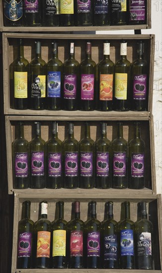Kusadasi, Aydin Province, Turkey. Sirince fruit wines produced locally displayed in wooden crates outside shop. Turkey Turkish Eurasia Eurasian Europe Asia Turkiye Aydin Province Kusadasi Sirince Fruit Wine Wines bottle Bottles Display Crate Crates Shop Store Destination Destinations European Middle East South Eastern Europe Vino Vin Alcohol Grape Winery Drink Western Asia