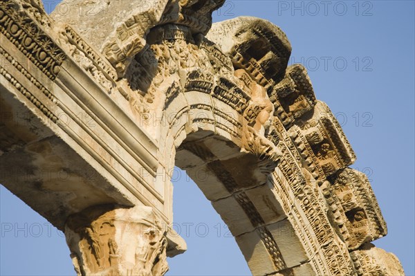 Selcuk, Izmir Province, Turkey. Ephesus. Detail of carved archway in ancient ruined city of Ephesus on the Aegean sea coast. Turkey Turkish Eurasia Eurasian Europe Asia Turkiye Izmir Province Selcuk Ephesus Ruin Ruins Roman Column Columns Facde Ancient Architecture Masonry Rock Stone Arch Blue Destination Destinations European History Historic Middle East South Eastern Europe Water Western Asia